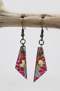 A pair of dangling earrings displayed on a clear acrylic stand against a light gray background. The earrings feature geometric triangular charms with a pink, blue, and white patterned background, accented by a small gold circular charm and dark metal fishhook wires.