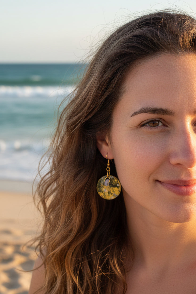 Handmade.  A pair of round dangle earrings with hand painted paper with textured green and gold circular faces. Sealed with an high gloss varnish. Gold hypoallergenic fishhook wires.