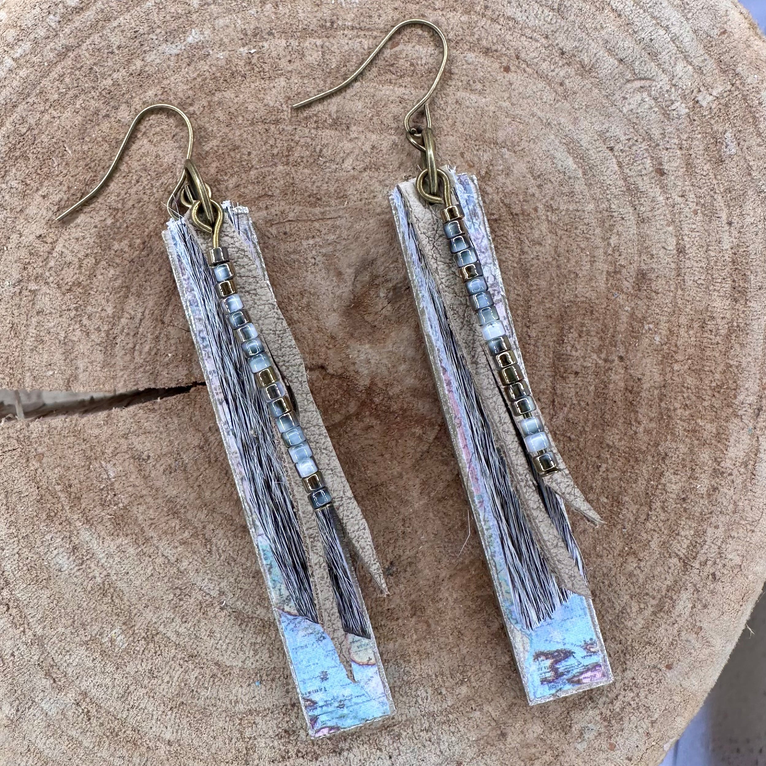 A pair of handmade dangle earrings with rectangular wood pieces covered with vintage maps, gray fur, recycled leather strips and small metallic beads. &nbsp;Hypoallergenic&nbsp;