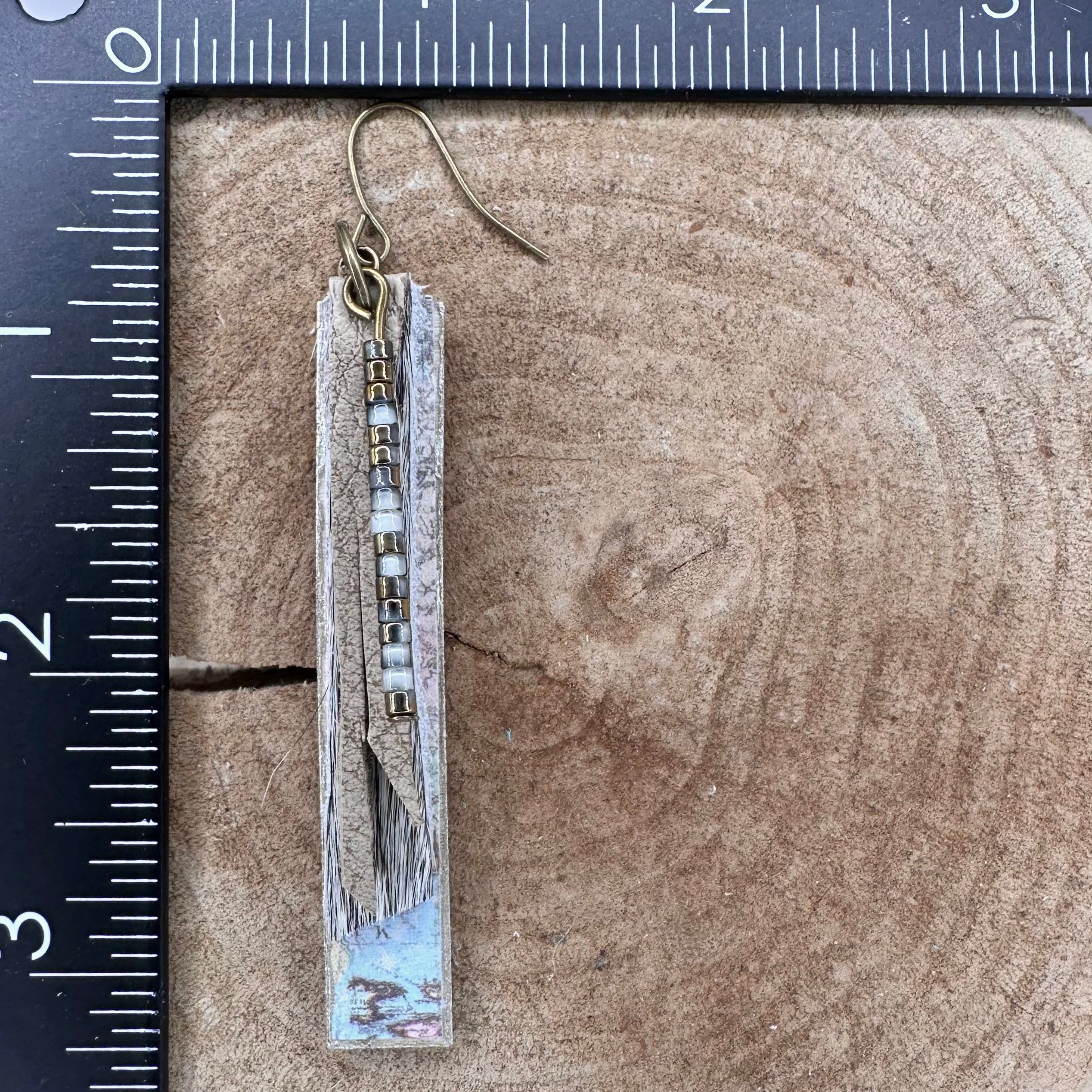 A pair of handmade dangle earrings with rectangular wood pieces covered with vintage maps, gray fur, recycled leather strips and small metallic beads. &nbsp;Hypoallergenic&nbsp;