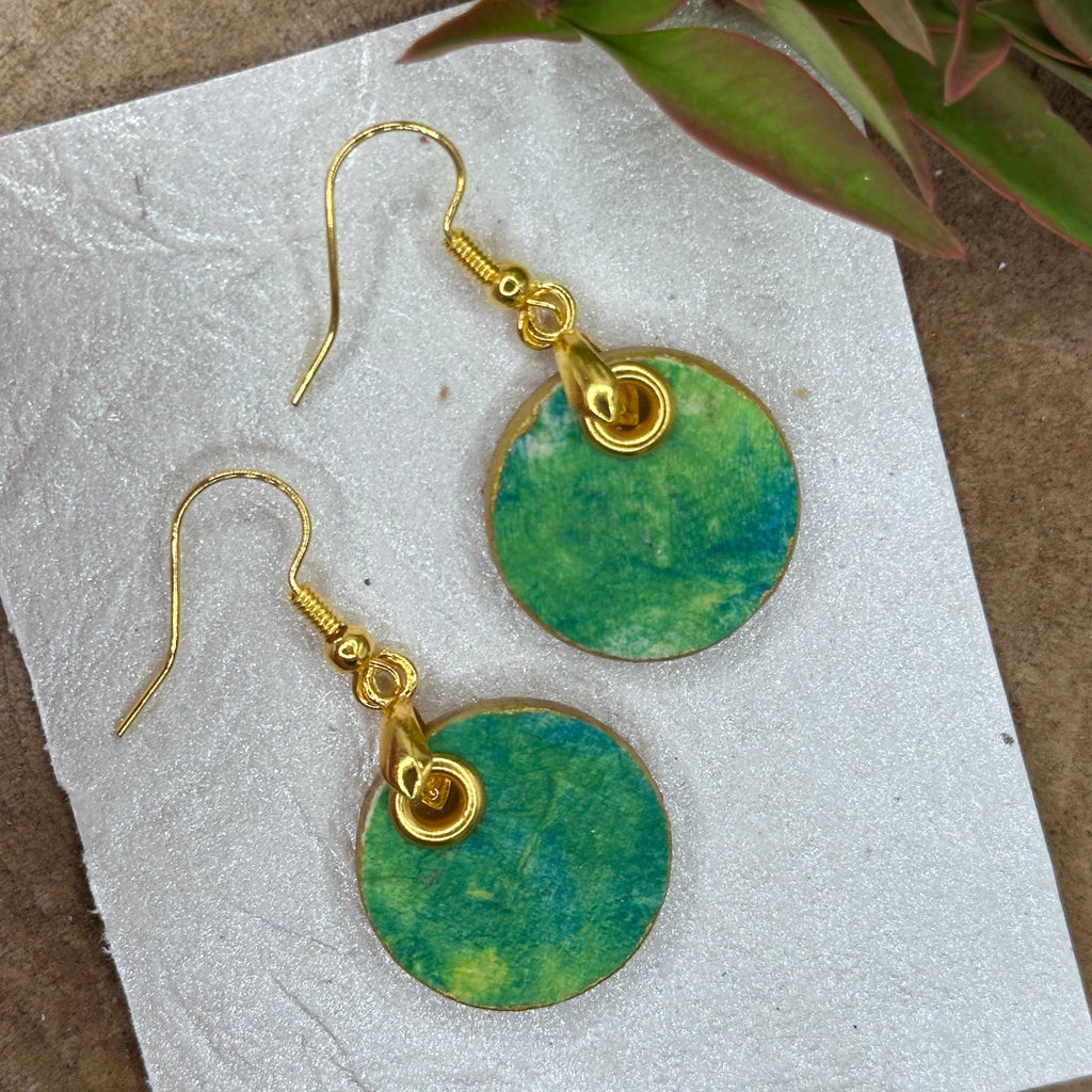 A pair of gold-tone dangle earrings with hand painted round green marbled pendants.  Hypoallergenic, one of a kind.