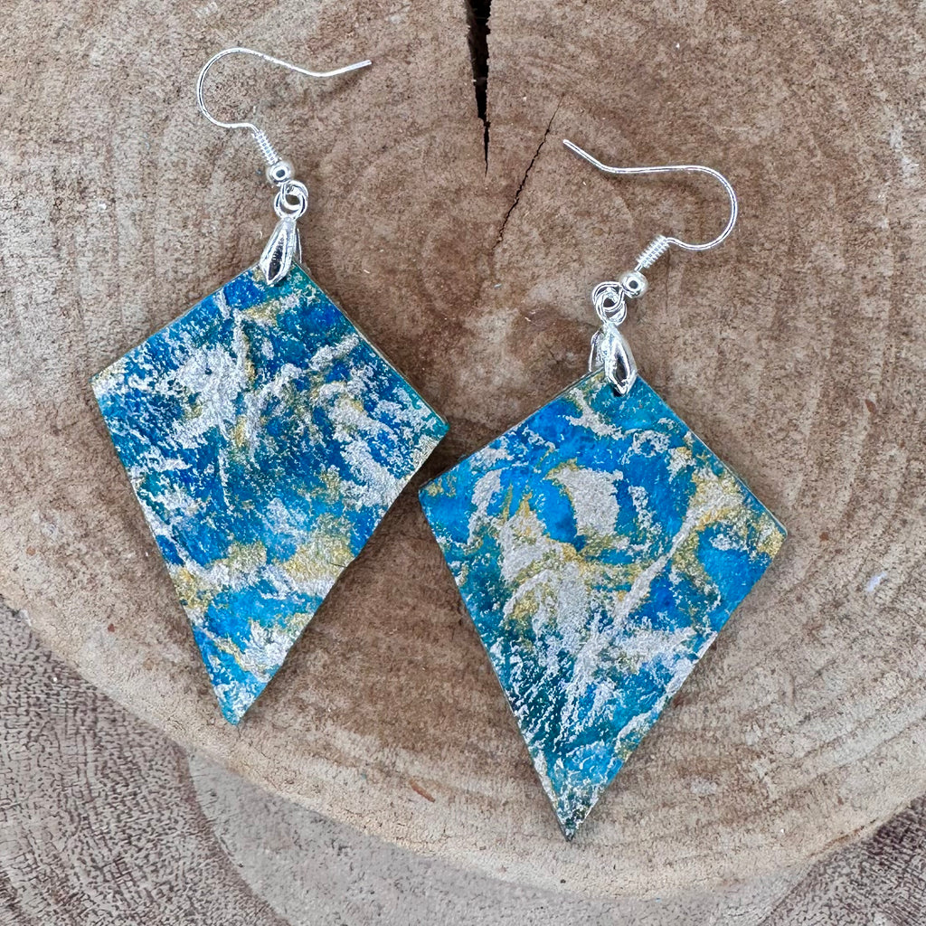 Hand painted earrings in marbled teal, green, and gold textured with silver-tone fishhook wires and diamond-shaped pendants. Sealed with a protective mat varnish. Hypoallergenic and light as a feather. ; 2" long not including the earring
