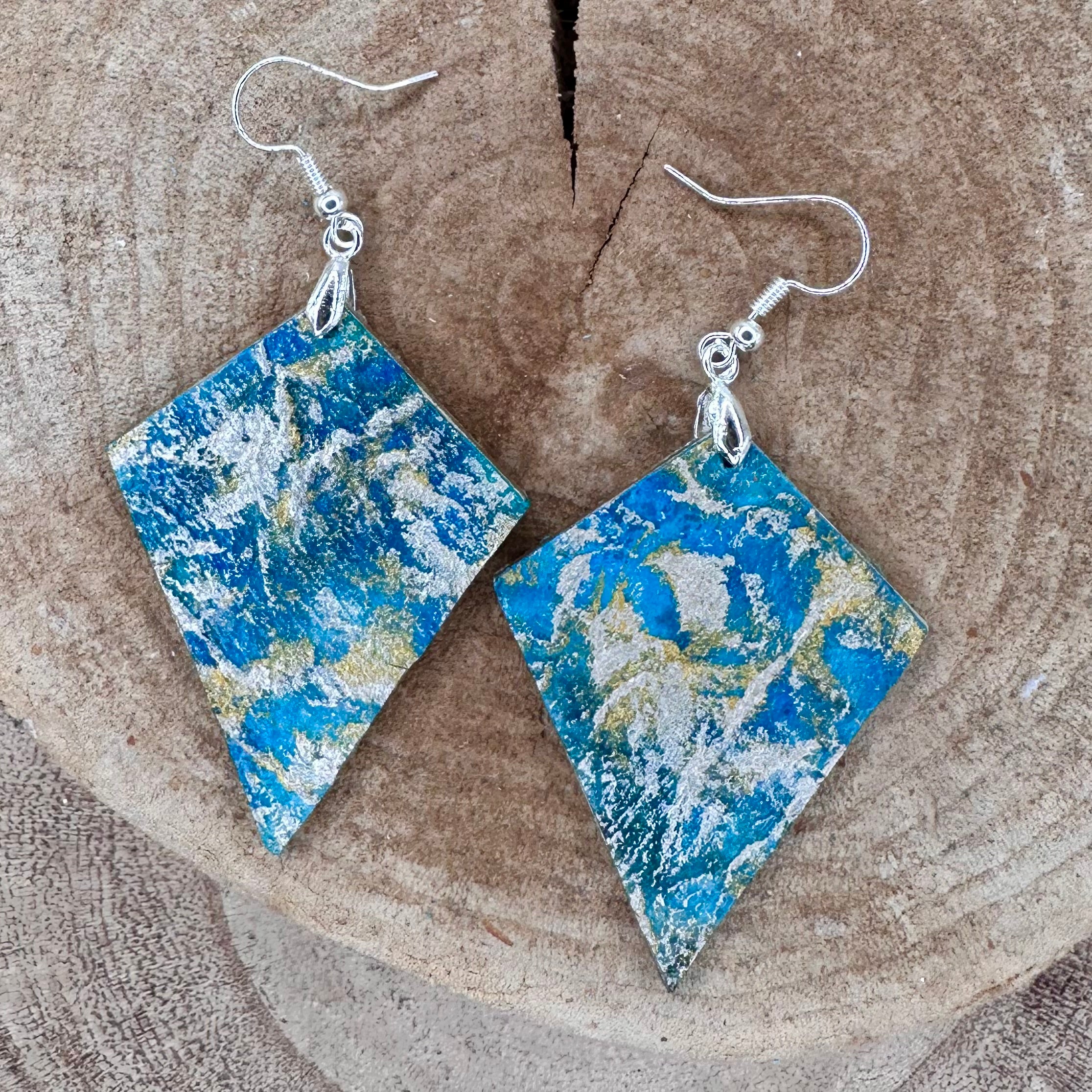 Hand painted earrings in marbled teal, green, and gold textured with silver-tone fishhook wires and diamond-shaped pendants. Sealed with a protective mat varnish. Hypoallergenic and light as a feather. ; 2" long not including the earring