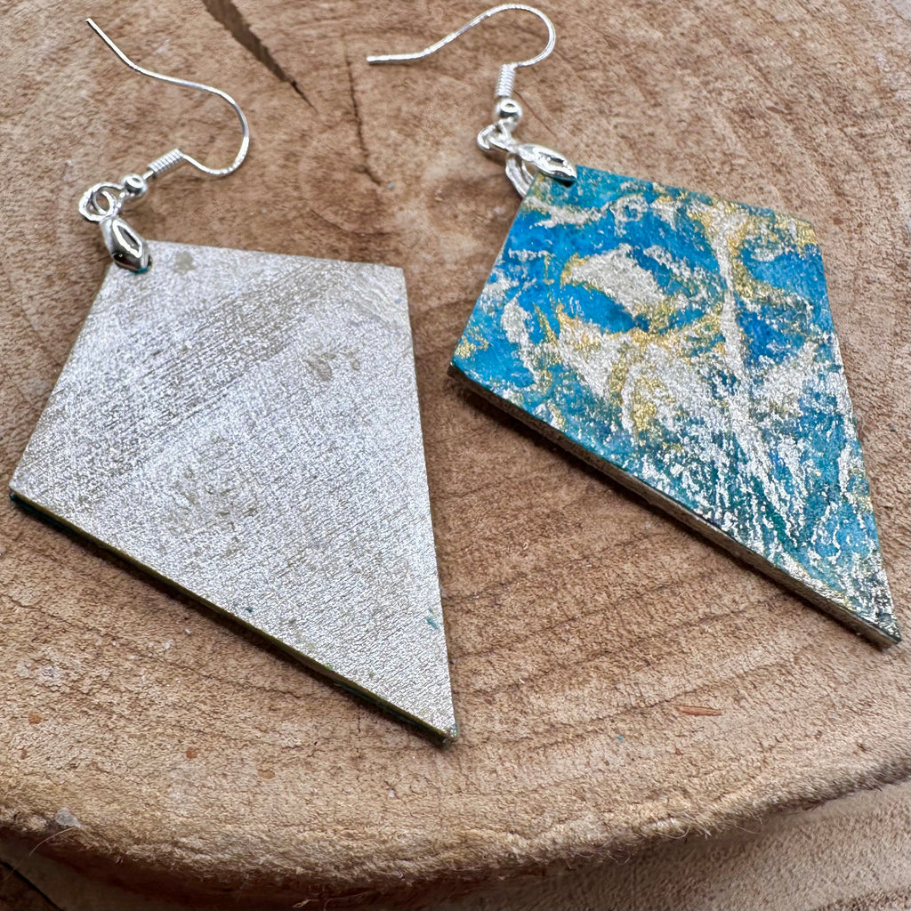 Hand painted earrings in marbled teal, green, and gold textured with silver-tone fishhook wires and diamond-shaped pendants. Sealed with a protective mat varnish. &nbsp;Hypoallergenic and light as a feather.&nbsp; 2" long not including the earring