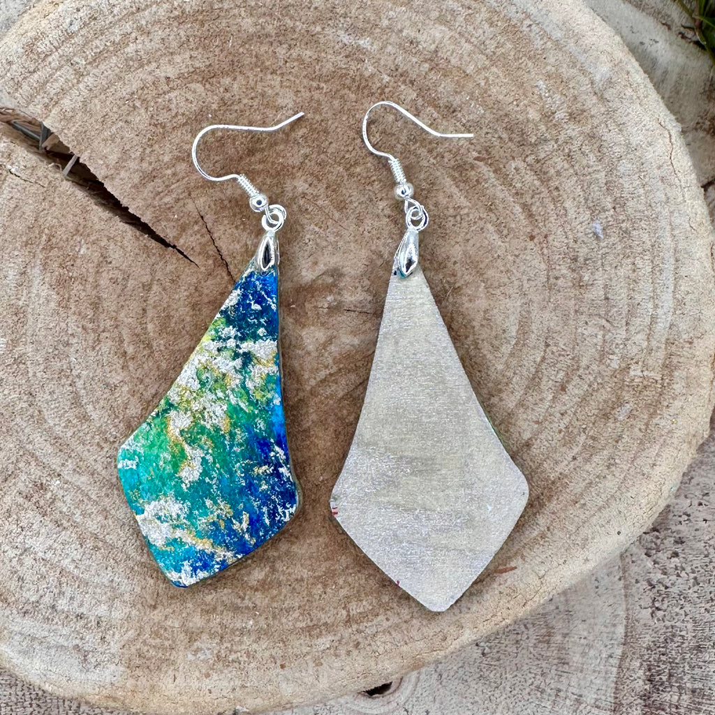 Hand painted earrings in marbled teal, green, and gold textured with silver-tone fishhook wires. Sealed with a protective mat varnish. &nbsp;Hypoallergenic and light as a feather.&nbsp; 2” long not including earring wire.