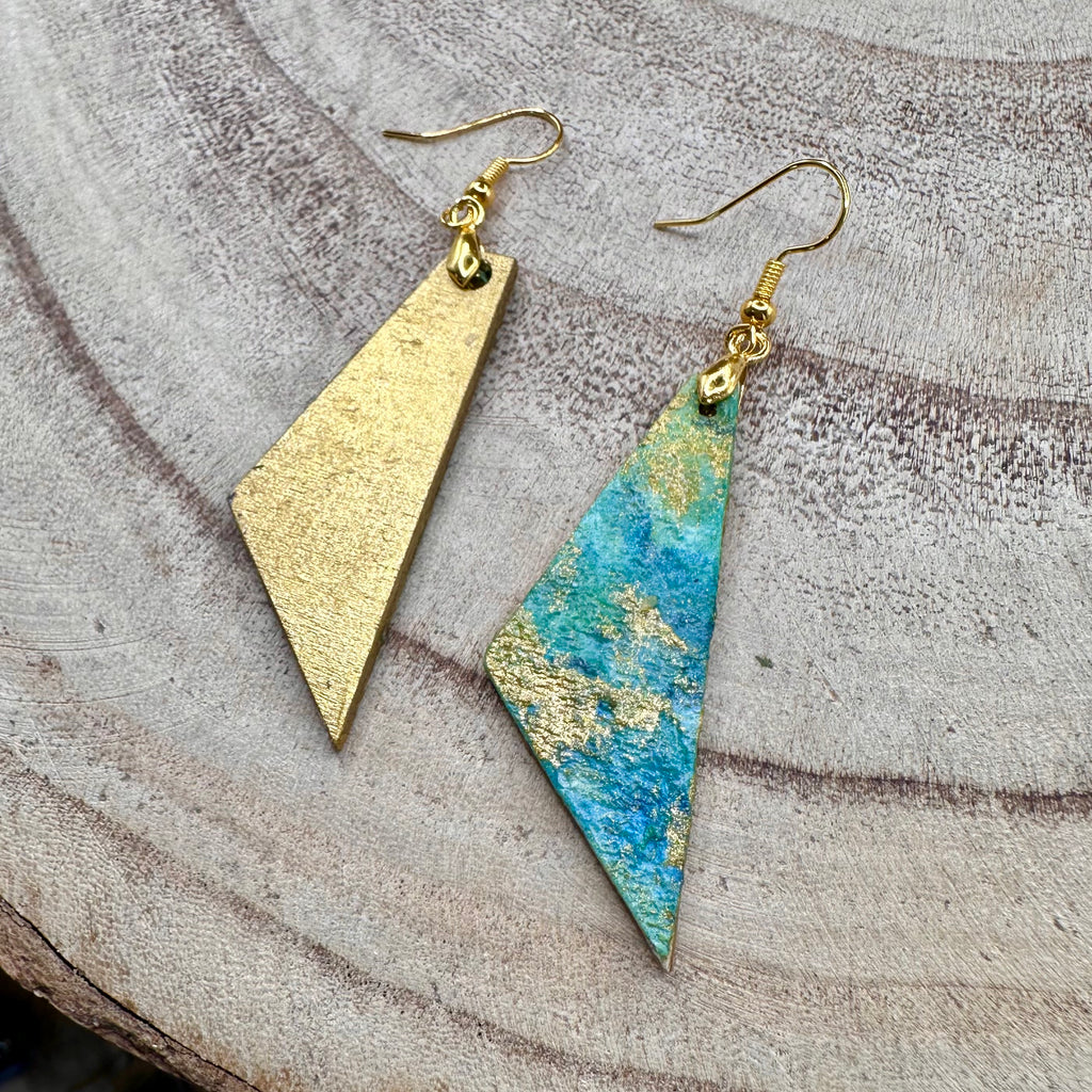 Hand painted earrings in marbled teal, green, and gold textured with gold-tone fishhook wires. Sealed with a protective mat varnish. &nbsp;Hypoallergenic and light as a feather. ;2” long not including earring wire.