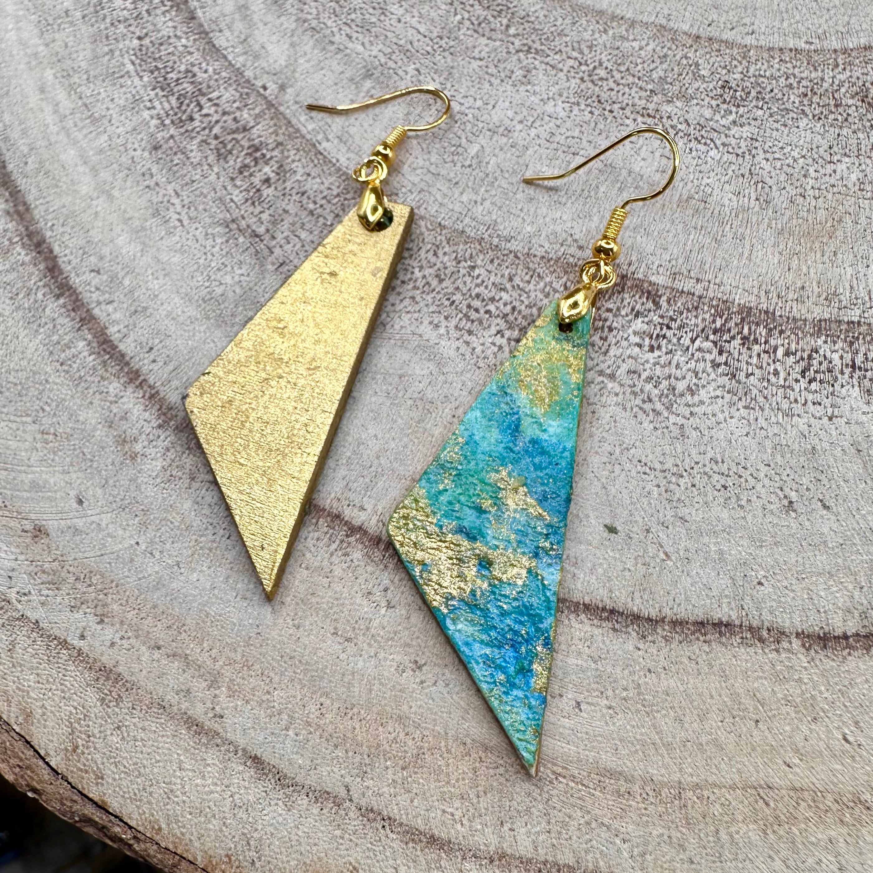 Hand painted earrings in marbled teal, green, and gold textured with gold-tone fishhook wires. Sealed with a protective mat varnish. &nbsp;Hypoallergenic and light as a feather. ;2” long not including earring wire.