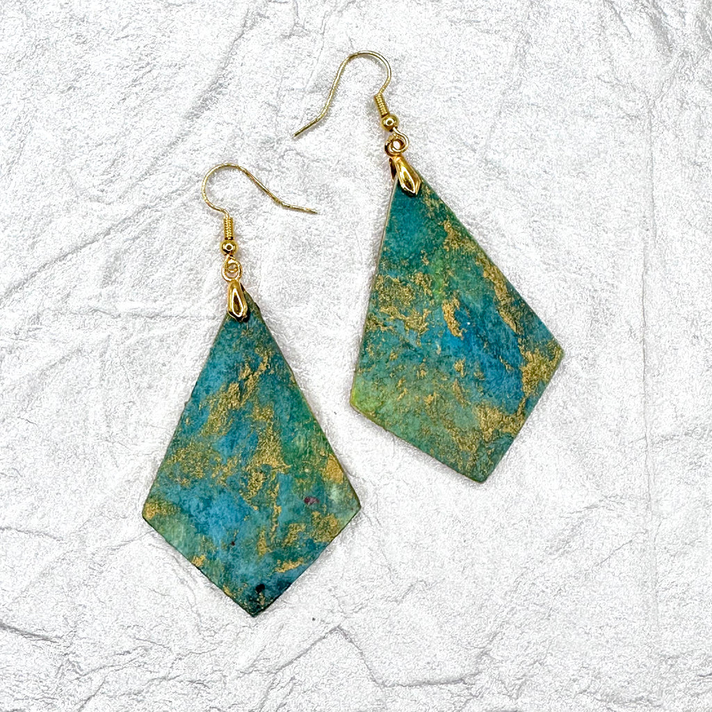 Hand painted earrings in marbled teal, green, and gold textured with gold-tone fishhook wires and diamond-shaped pendants. Sealed with a protective mat varnish. Hypoallergenic and light as a feather. 2” long not including earring wire.
